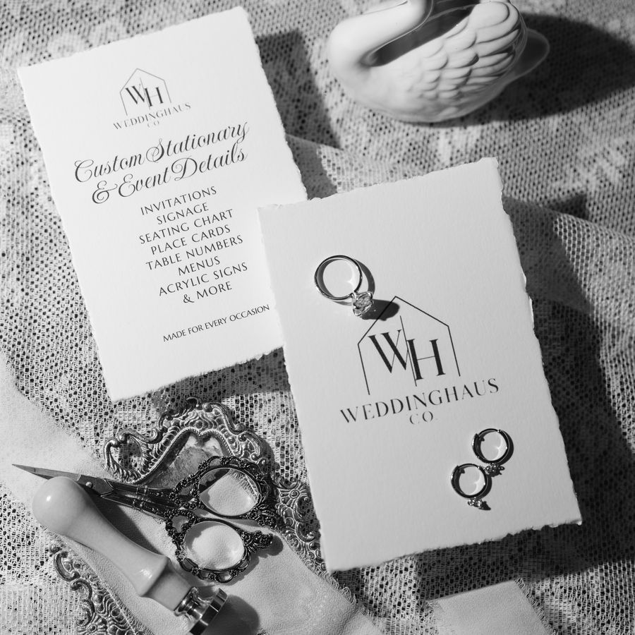 Black and white photo of WeddingHaus Co. cards with rings