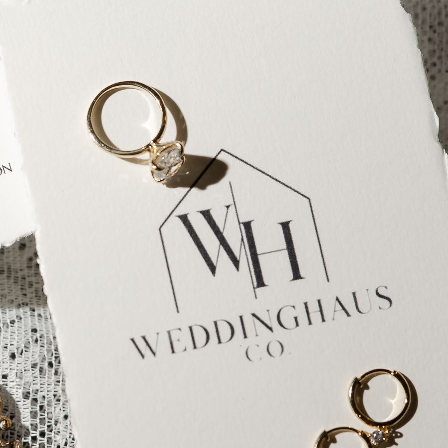 WeddingHaus Co. logo card with a gold engagement ring and earrings